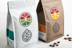 Two modern coffee packaging pouches in white and kraft designs with colorful circular logos and coffee beans nearby.
