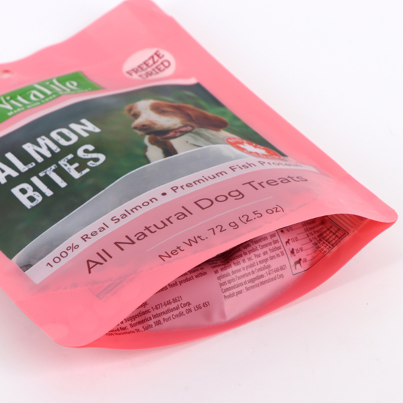 Close-up of pink resealable pouch for salmon dog treats showing bottom gusset.