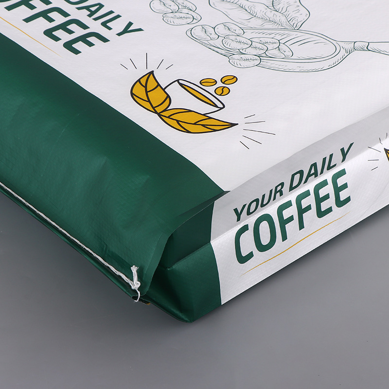 Close-up of green and white coffee packaging bag with printed “Your Daily Coffee” and sealed bottom.