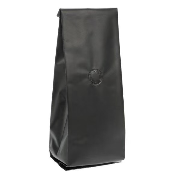 Matte black coffee bag with degassing valve, standing pouch style and no visible branding.