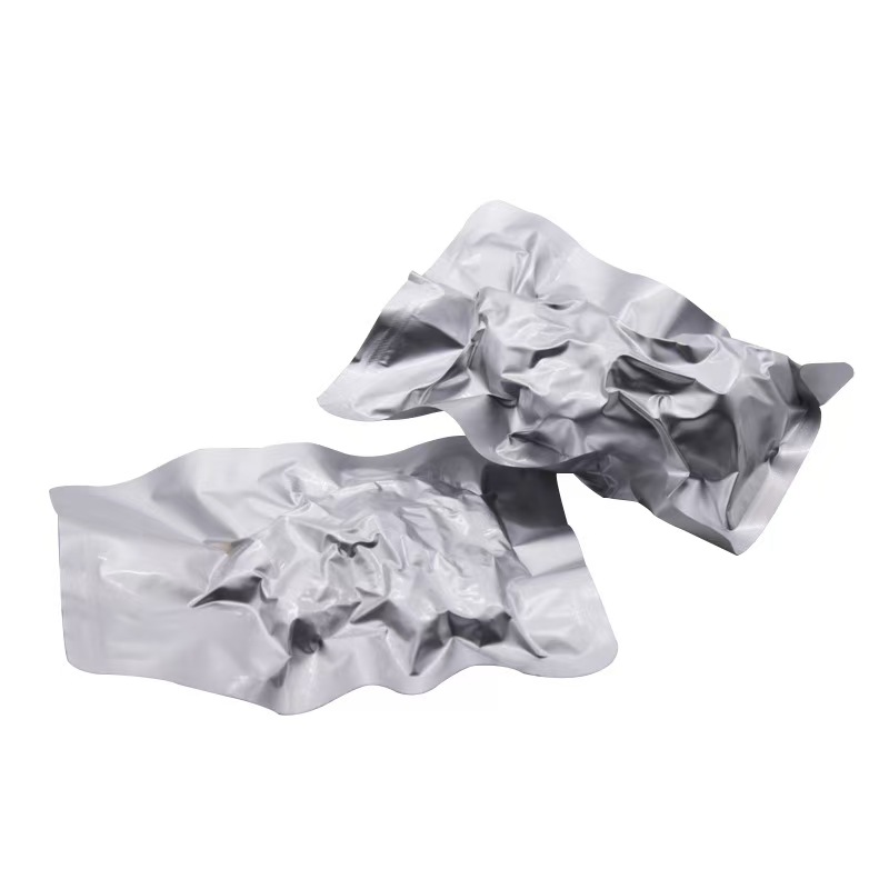 Silver vacuum-sealed retort pouches with high-temperature resistance, used for ready-to-eat meals or industrial food packaging.