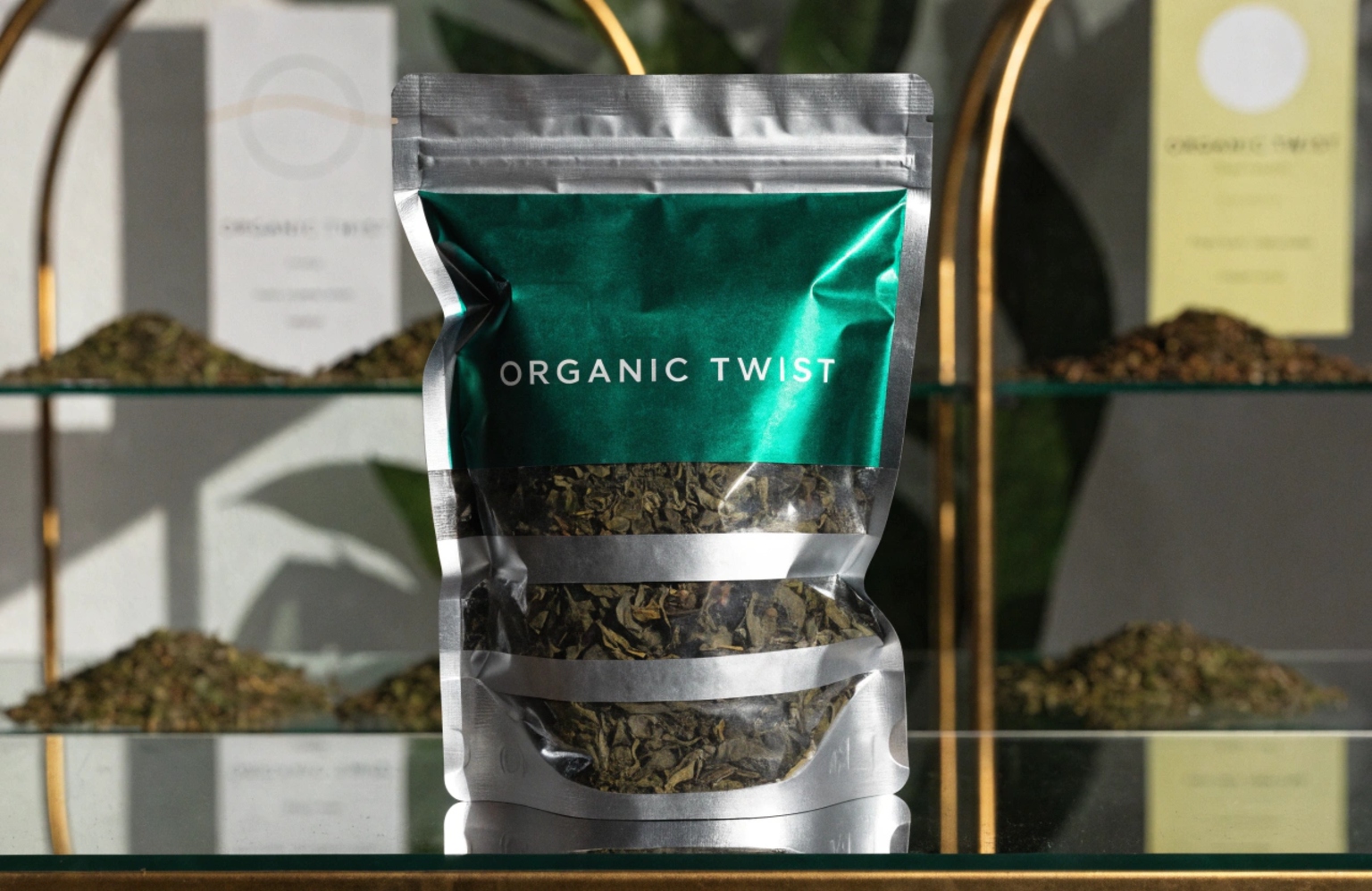 Metallic green stand-up pouch with clear window showing loose tea leaves